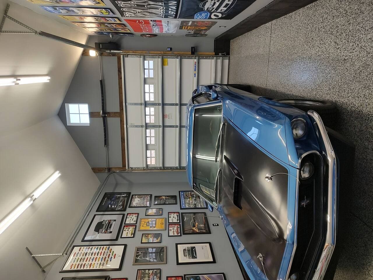 Garage remodel showing wall-mounted storage and clean flooring