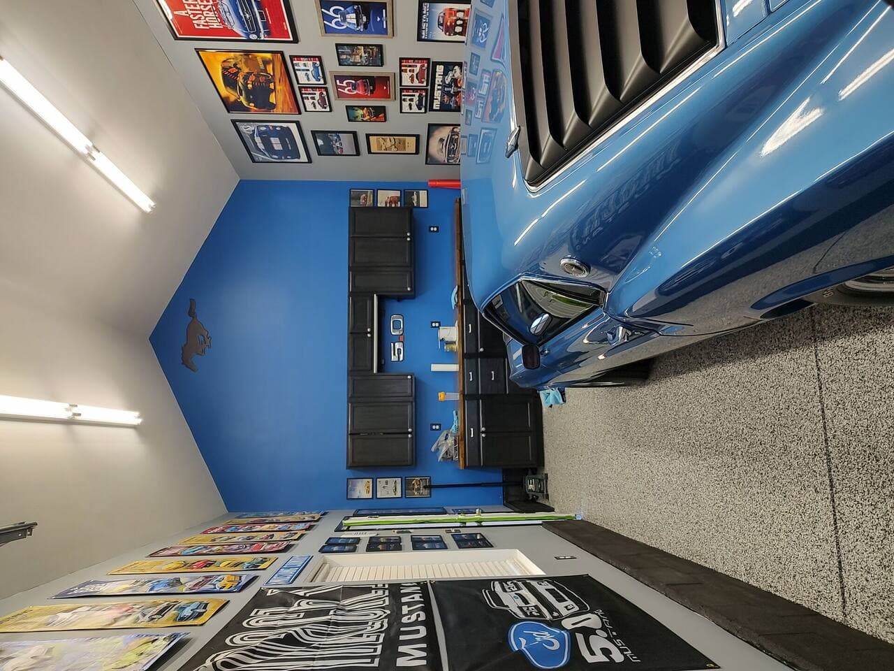Garage renovation featuring workbench zone with overhead storage