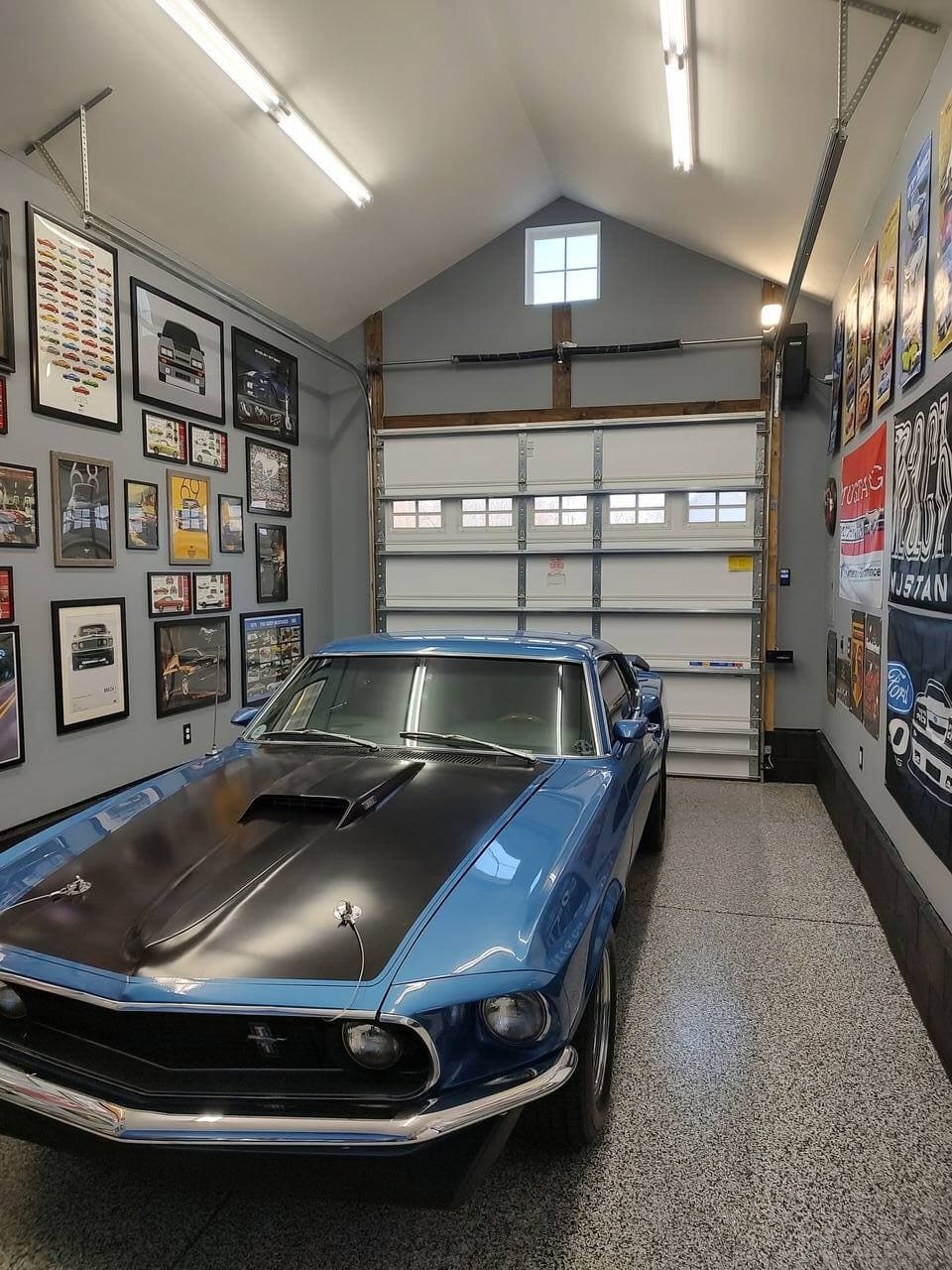 Garage remodel showing wall-mounted storage and clean flooring