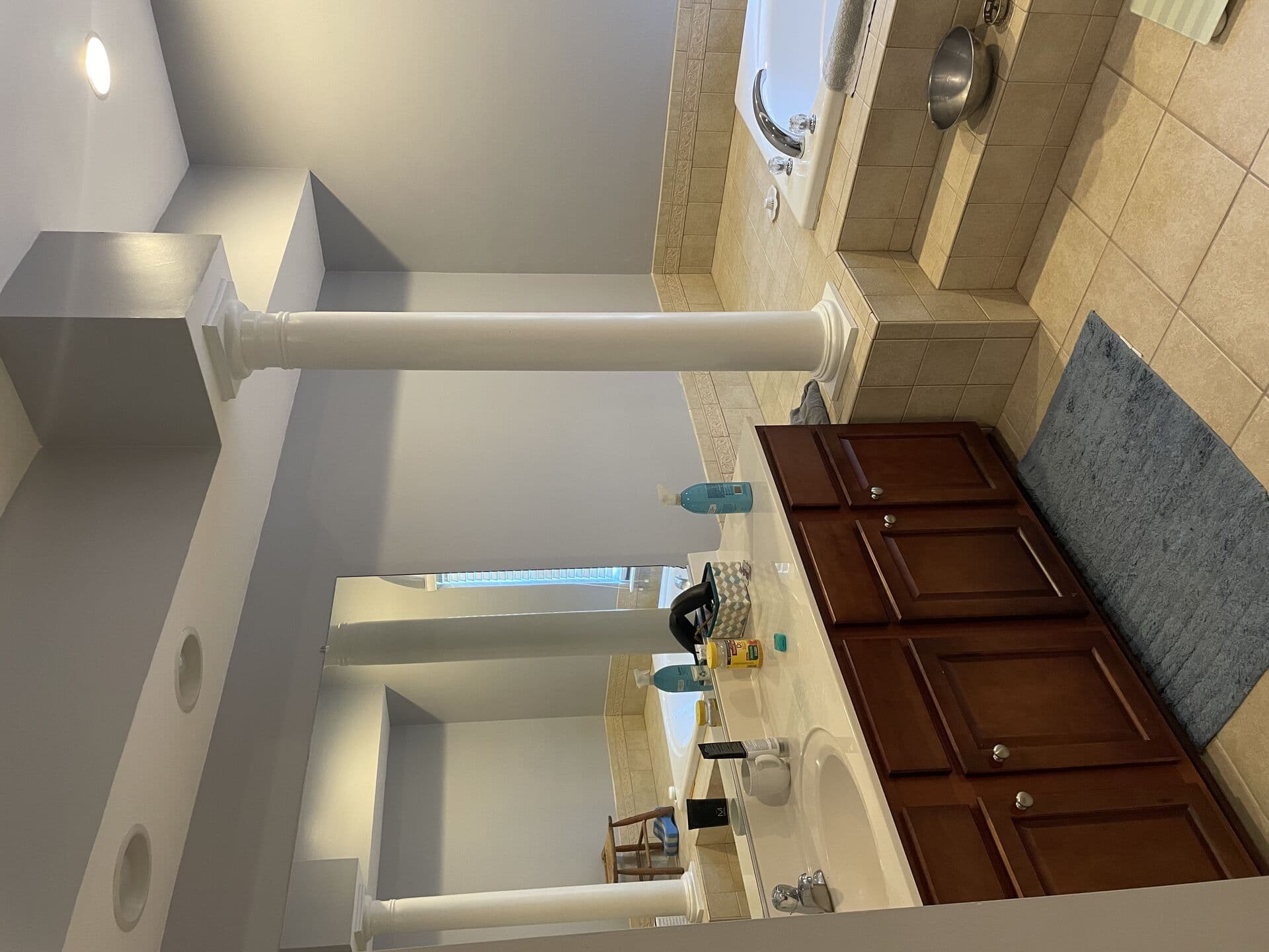Small shower enclosure with dated tile before the remodel