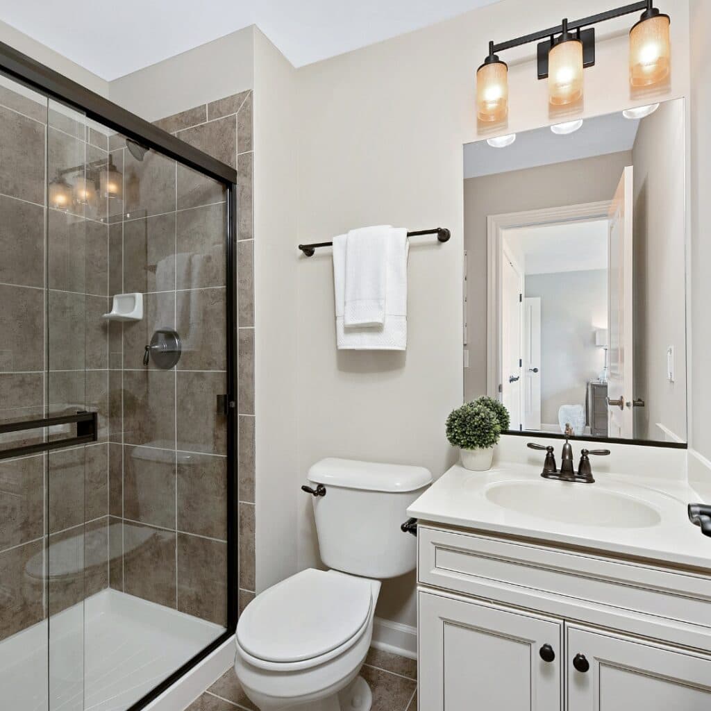 Completed bathroom renovation with new tile installation and modern amenities