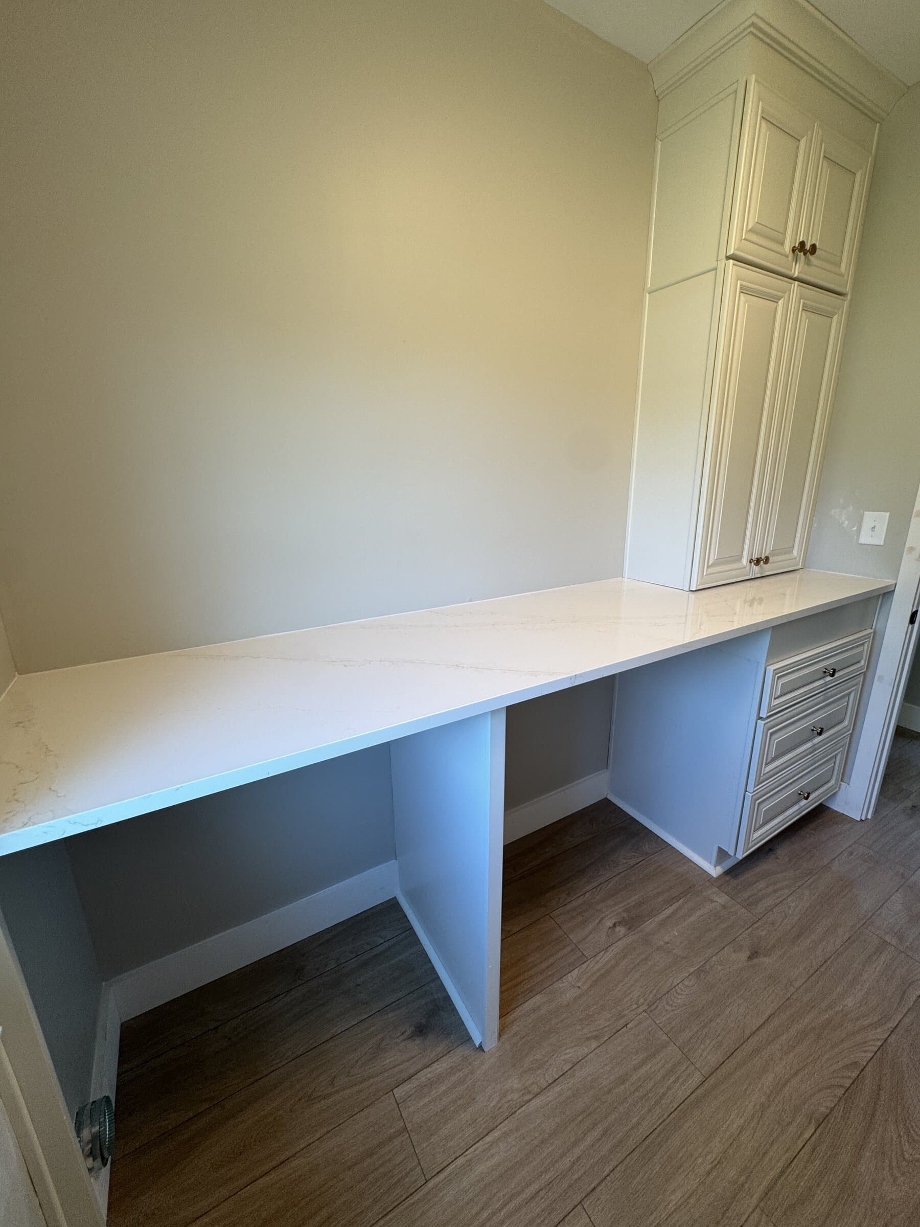 Custom laundry room remodel with cabinetry and tile flooring at Hunters Trace