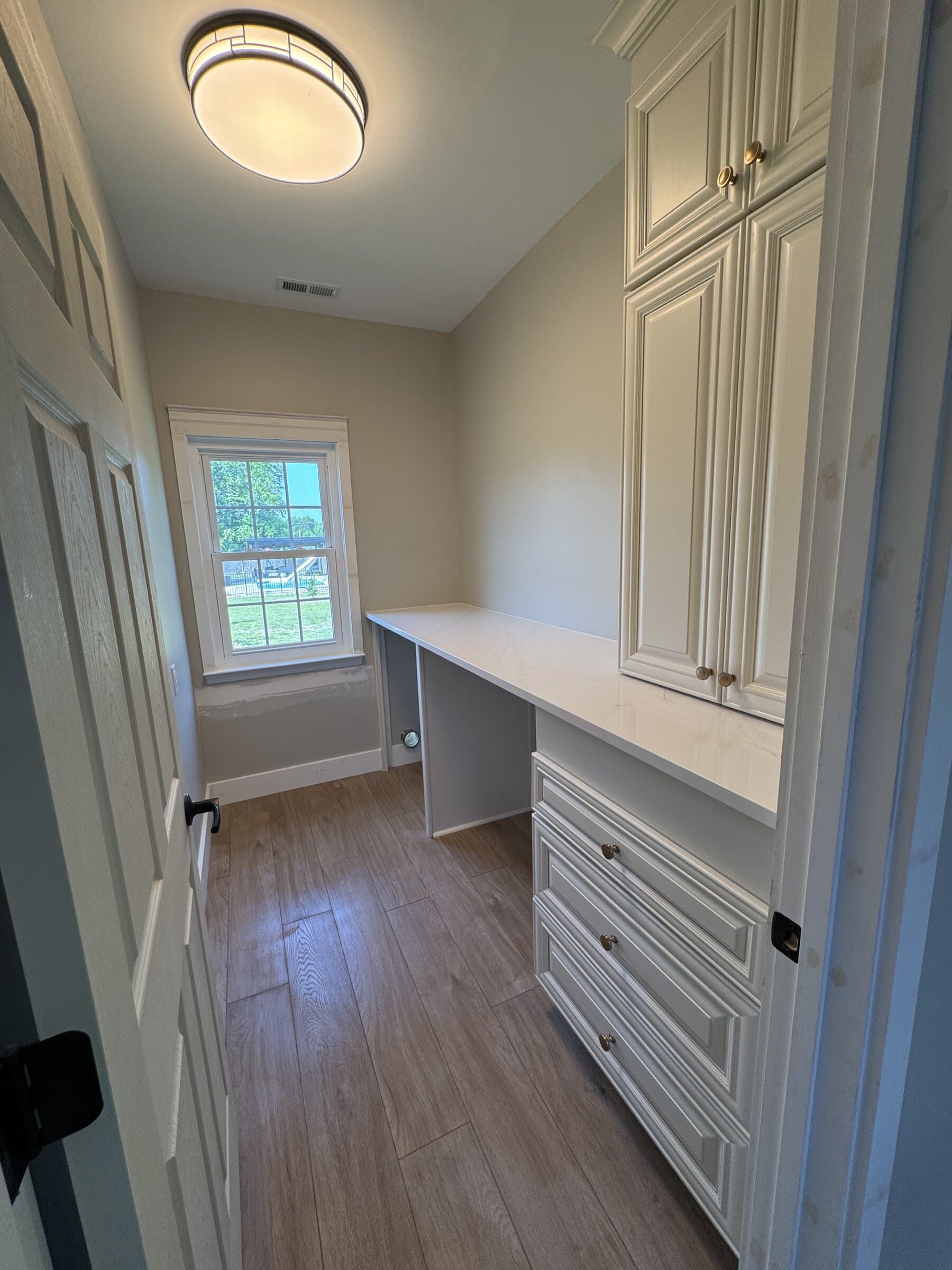 Laundry room renovation featuring updated storage and finishes at Hunters Trace